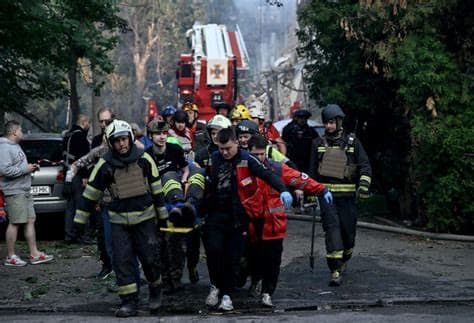 Ukrainian rescuers clear rubble as Kyiv mourns 30 killed in Russian attack