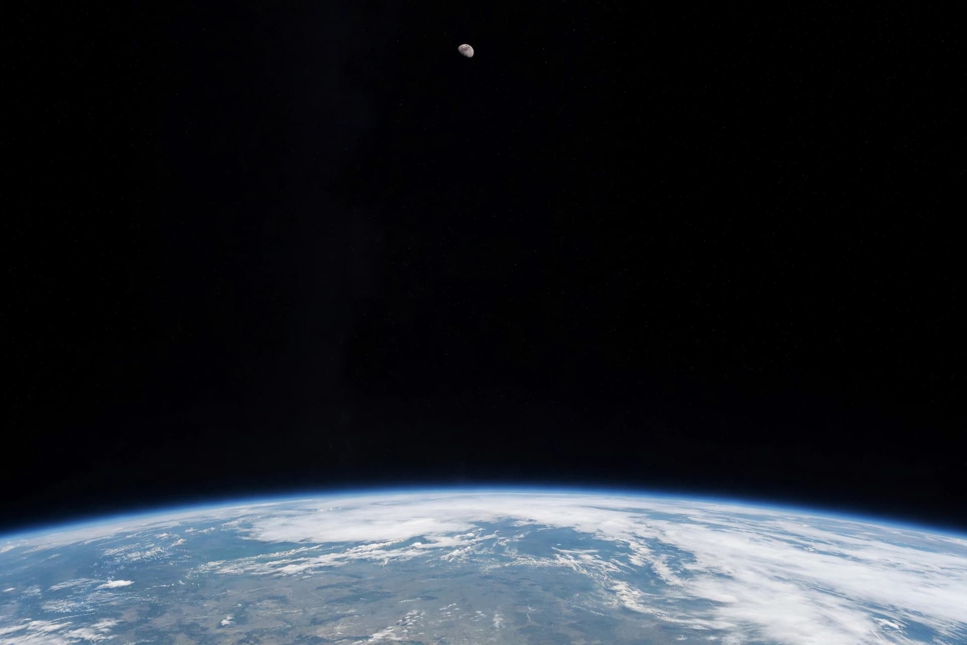 A Small Moon Beyond the Curve of Home. 