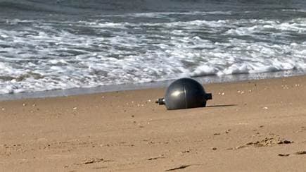 Strange balls found on Queensland beaches could be toxic ‘space debris’, experts warn