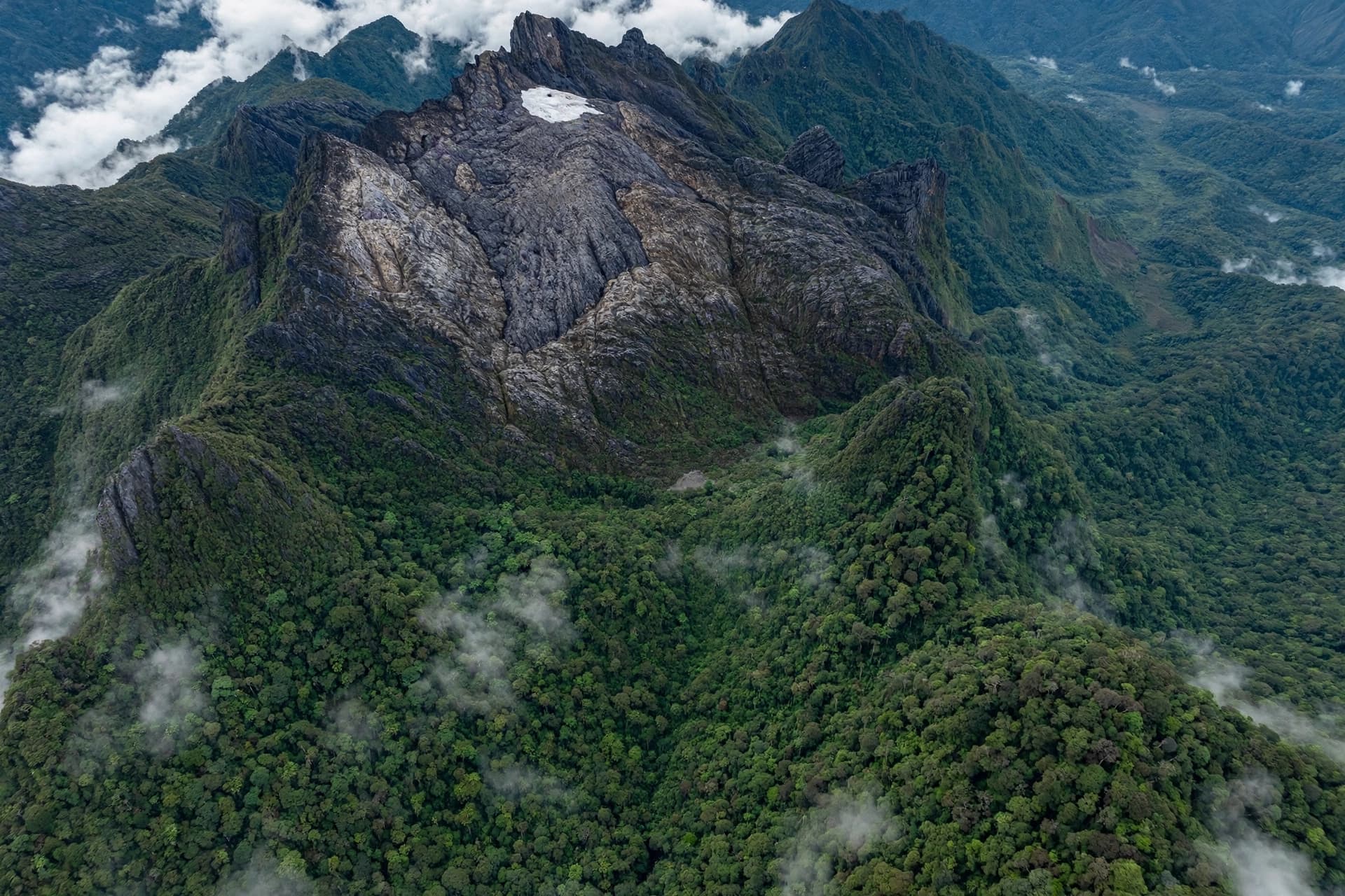 A mountain the Amungme called the White Arrow is losing its last white A mountain the Amungme called the White Arrow is losing its last white